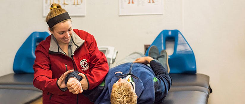 athletic trainer helping a student