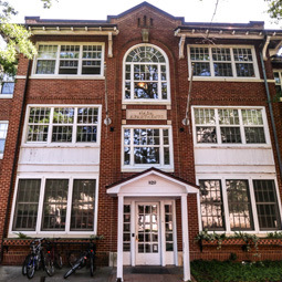 A lower front angle of the brick 820 Henderson Street housing building, showcasing it's three stories.