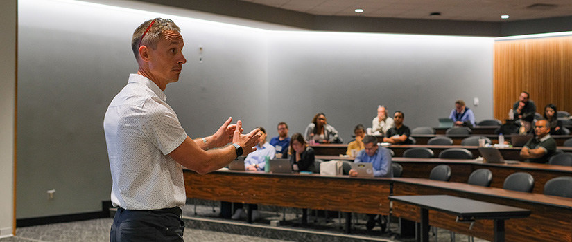 Michael Beets presents to a room of faculty members