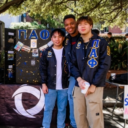 A group of students at a table setup outside.