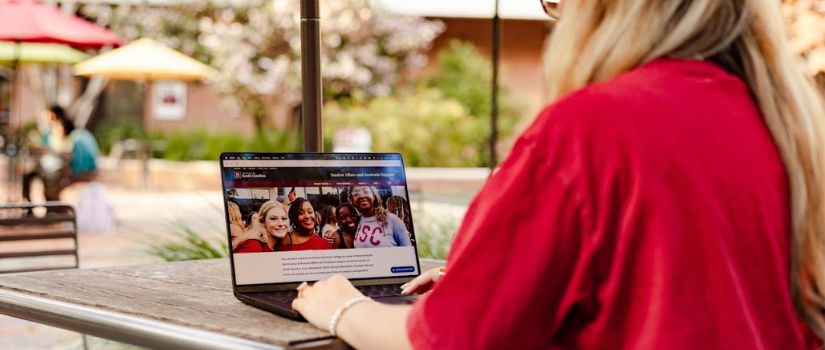 Student looking at the Student Affairs and Academic Support website homepage