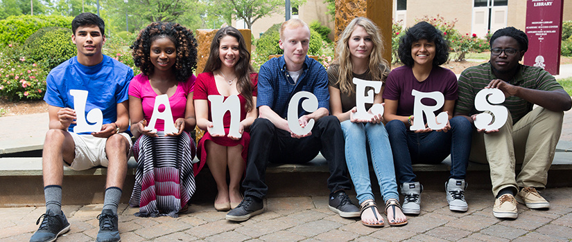 Students by the fountain in front of Medford Library