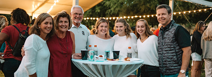 Family gathered around a table at the Rock the Roost event.