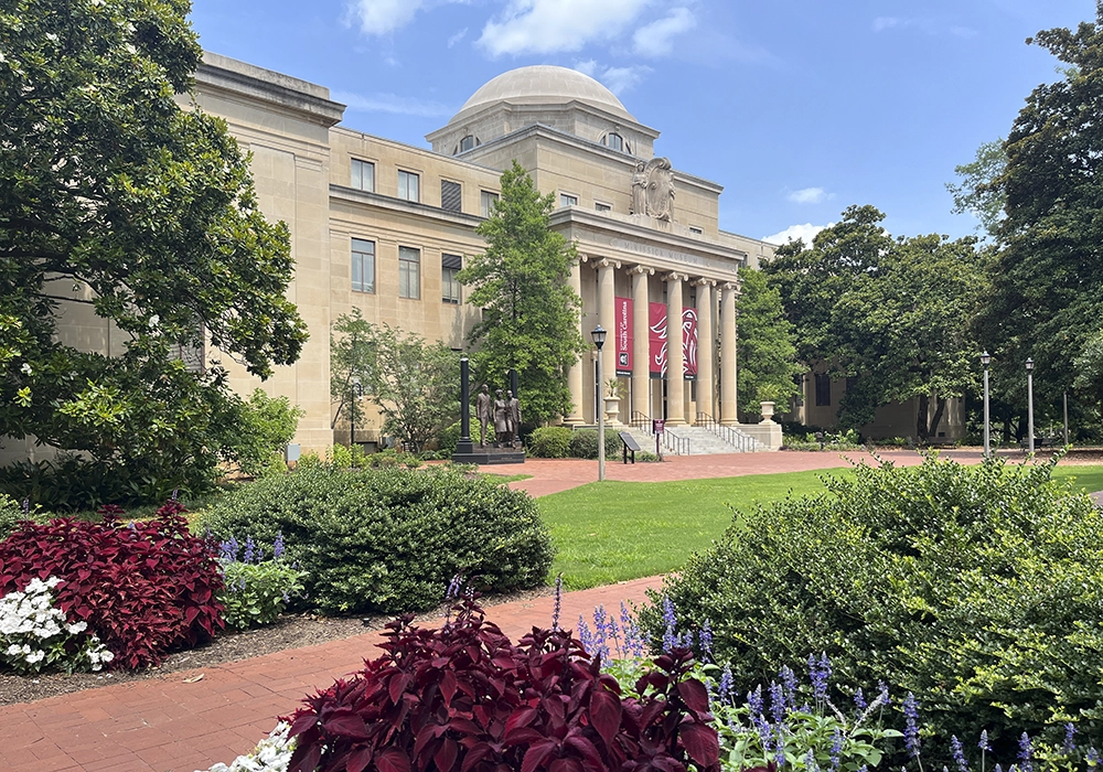 McKissick Museum sits at the top of the historic Horseshoe with large garnet banners featuring tailfeathers.