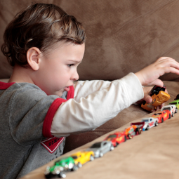 little boy playing with cars