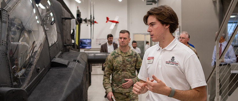 a male student works on a machine in the aerospace center