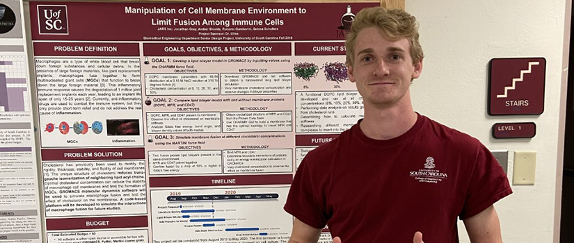 Jonathan Gray stands in front of research poster.