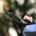 Cropped image of someone tapping on a tablet.