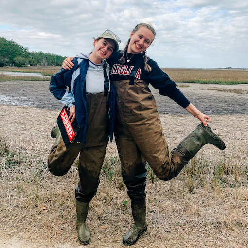 Two Honors students in wading gear at the Baruch Institute on the SC coast. 