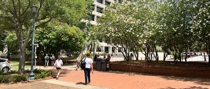 Students walk around out the the Close-Hipp Building.