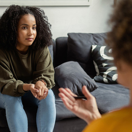 A student speaks with a counselor in their office.