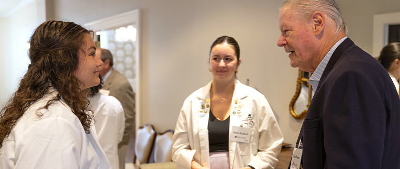 Donor and students speaking at an event