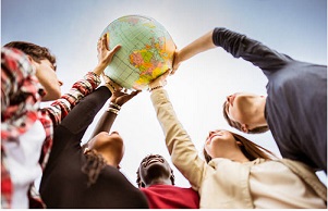 Group of people holding up a globe