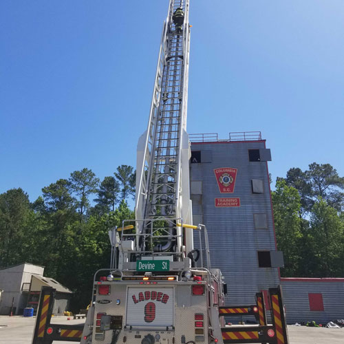 Tracy Whelen on ladder at Columbia-Richland Fire Department training academy.