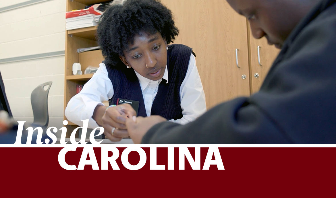 graphic that has a frame with the words Inside Carolina over an image of two people sitting at a table looking at papers with a cabinet and bookcase in the background