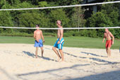 Students playing sand volleyball