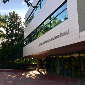 A photo of the outside of the sleek, new center for well being building on campus.