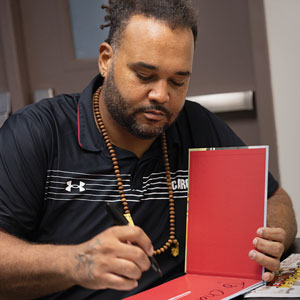 Langston Moore signs a copy of his book.