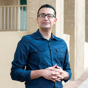 Roozbeh Behroozmand stands outside a building