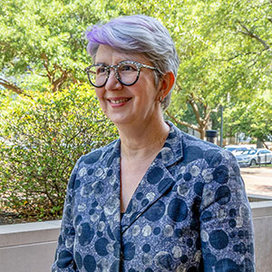 Carol Harrison smiles outside on USC's campus