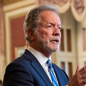 David Beasley stands at podium