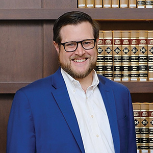 A man standing in front of a bookcase