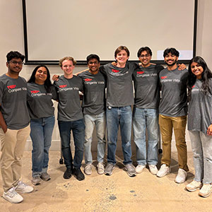 A group of eight USC students standing together in a line